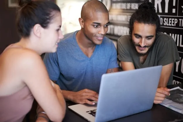 A group of diverse employees participating in a cybersecurity training session, with a projection screen showing a presentation about identifying phishing emails and safe online practices.