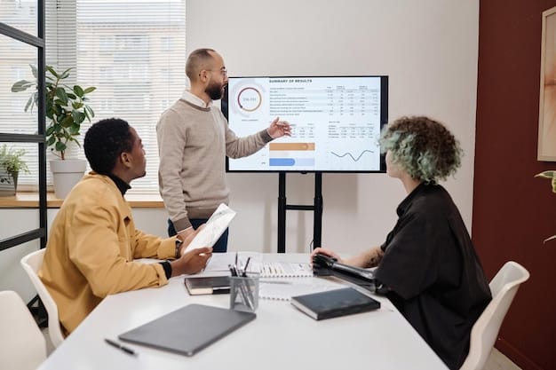 A diverse group of professionals collaborates around a table in a modern office, reviewing charts and graphs on a large screen. The atmosphere is positive and collaborative, symbolizing career advancement and teamwork.