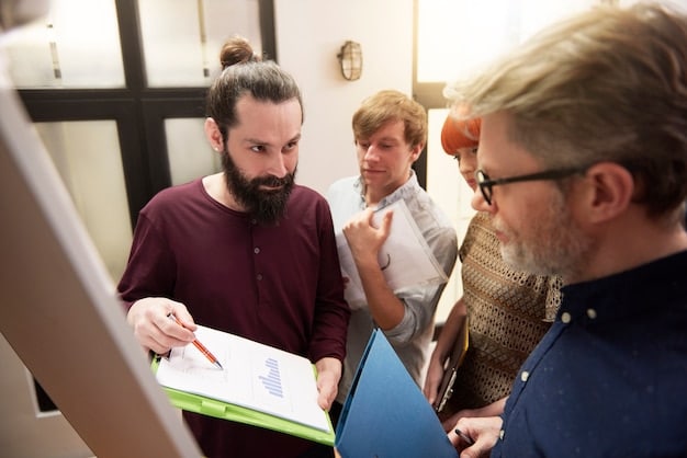 A group of teachers participating in a professional development workshop, with a presenter leading a discussion and teachers actively taking notes.