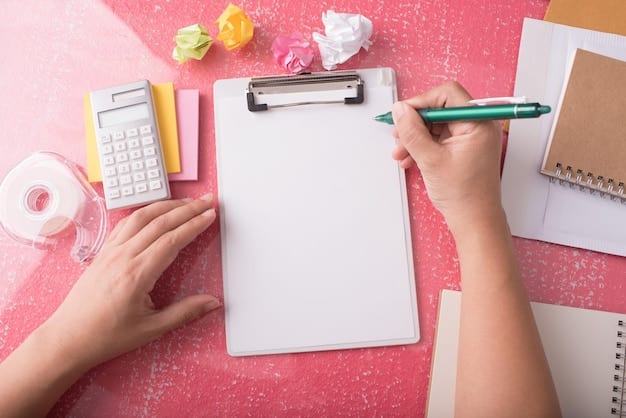 A hand holding a pen and filling out Schedule 8812, with a calculator and supporting documents neatly arranged on the desk.