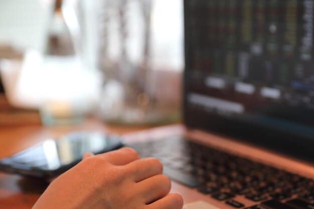 A close-up of hands entering data into a tax software program on a laptop, with a satisfied expression on the person's face. The background is blurred, focusing attention on the screen and hands.