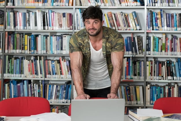 A veteran sitting at a desk in a library, surrounded by books and a laptop, focused on their studies, with a determined and hopeful expression, symbolizing the hard work and dedication required to succeed in college.