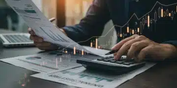 Person reviewing tax documents with a calculator, symbolizing financial planning and tax optimization.